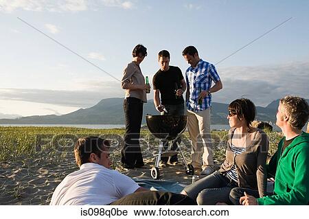 Friends having a barbecue on an island View Large Photo Image Stock Image - Friends having a barbecue on an island. Fotosearch