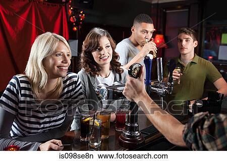 Friends in bar View Large Photo Image Picture - Friends in bar. Fotosearch