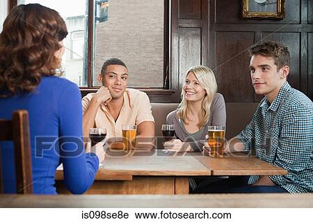 Stock Image - Friends in bar. Fotosearch