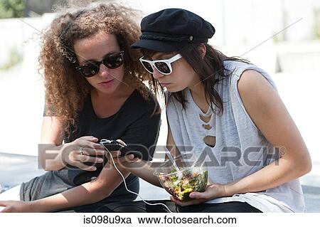 Friends looking at mp3 player View Large Photo Image Stock Image - Friends looking at mp3 player. Fotosearch