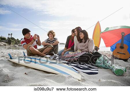 Friends on beach with surfboard View Large Photo Image Stock Photo - Friends on beach with surfboard. Fotosearch