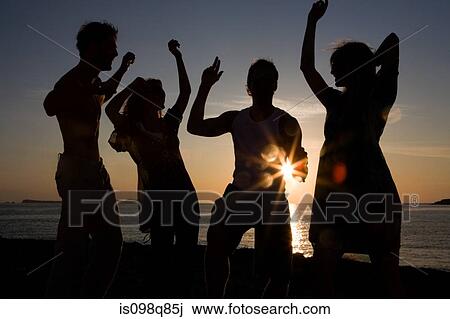 Stock Image - Friends partying on beach. Fotosearch