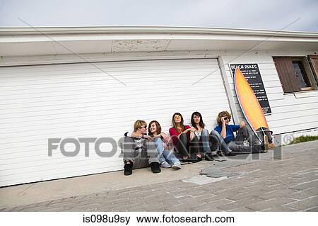 Friends sitting on floor with surfboard View Large Photo Image Stock Photo - Friends sitting on floor with surfboard. Fotosearch