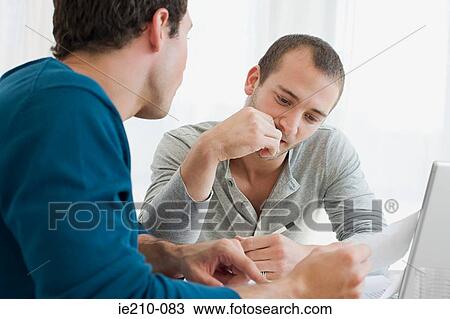 Gay couple doing finances View Large Photo Image Stock Image - Gay couple doing finances. Fotosearch