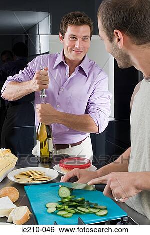 Stock Photograph - Gay couple in kitchen. Fotosearch