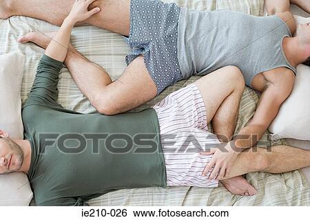 Stock Photograph - Gay couple sleeping. Fotosearch