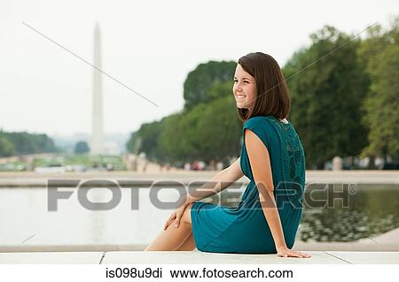 Stock Image - Girl by reflecting pool with washington monument in distance. Fotosearch