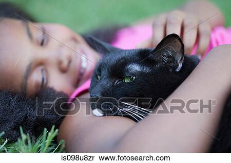 Girl cuddling cat View Large Photo Image Stock Photography - Girl cuddling cat. Fotosearch