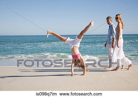 Girl doing handstand at beach View Large Photo Image Picture - Girl doing handstand at beach. Fotosearch