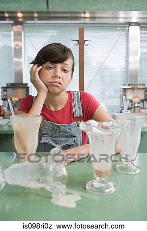 Girl feeling sick after milkshakes View Large Photo Image Stock Photo - Girl feeling sick after milkshakes. Fotosearch