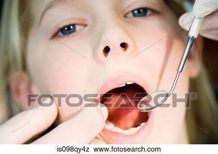 Stock Photo - Girl having dental check up. Fotosearch