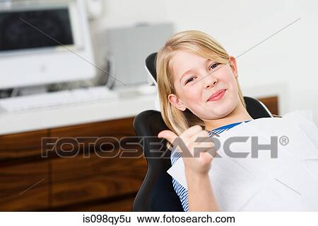 Stock Photograph - Girl in dentists chair. Fotosearch