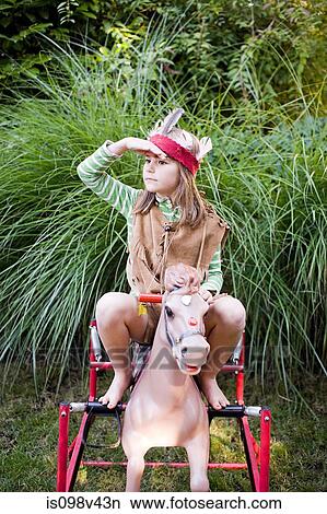 Girl in Native American costume on rocking horse View Large Photo Image Picture - Girl in Native American costume on rocking horse. Fotosearch