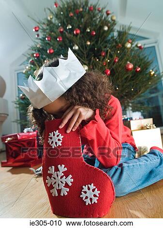 Girl looking in a christmas stocking View Large Photo Image Stock Image - Girl looking in a christmas stocking. Fotosearch