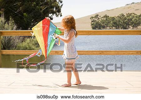 Girl on jetty with kite View Large Photo Image Stock Photography - Girl on jetty with kite. Fotosearch