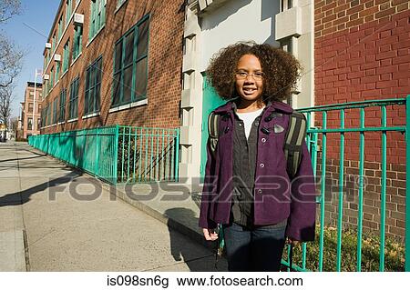 Stock Image - Girl outside school. Fotosearch
