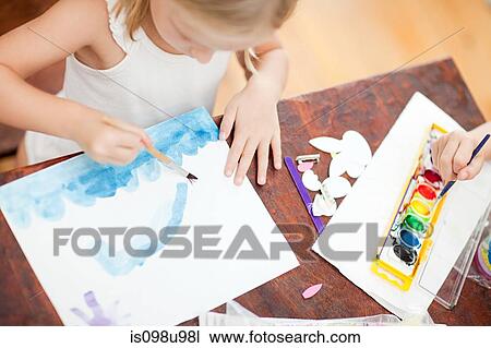Stock Image - Girl painting with watercolors. Fotosearch