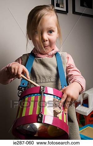 Girl playing a drum View Large Photo Image Stock Image - Girl playing a drum. Fotosearch