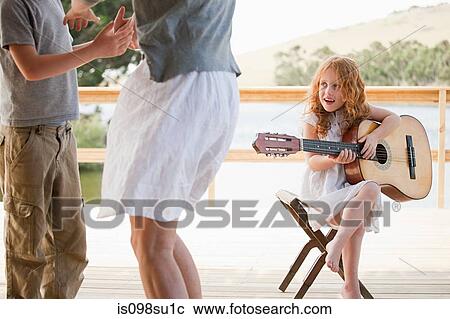 Stock Image - Girl playing guitar. Fotosearch