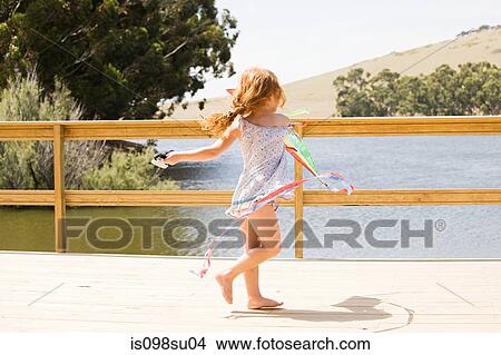 Picture - Girl playing on jetty. Fotosearch