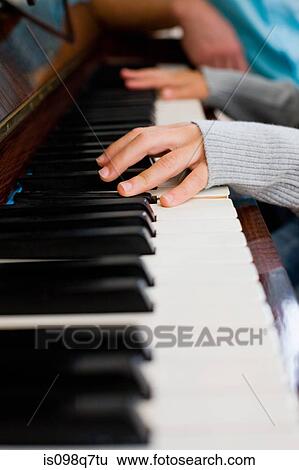 Stock Photograph - Girl playing piano. Fotosearch