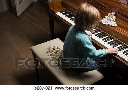 Stock Image - Girl playing the piano. Fotosearch