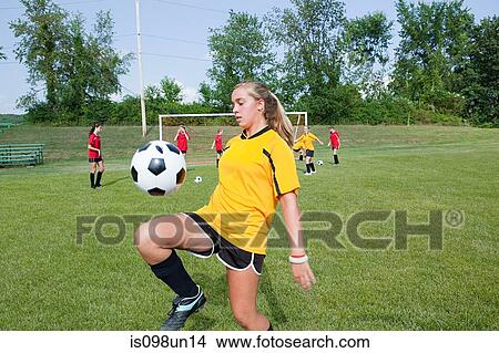 Picture - Girl practicing soccer skills. Fotosearch