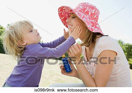 Girl putting suncream on mother View Large Photo Image Stock Image - Girl putting suncream on mother. Fotosearch
