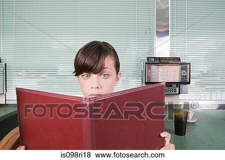 Girl reading a menu in a diner View Large Photo Image Stock Photo - Girl reading a menu in a diner. Fotosearch
