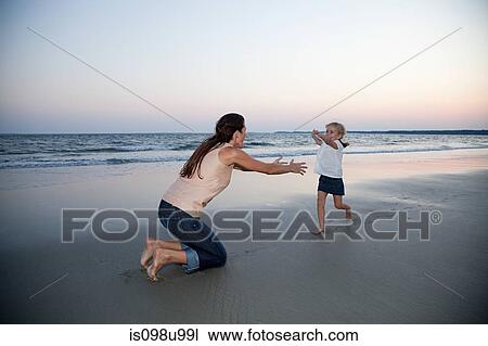 Girl running to mother on beach View Large Photo Image Stock Image - Girl running to mother on beach. Fotosearch