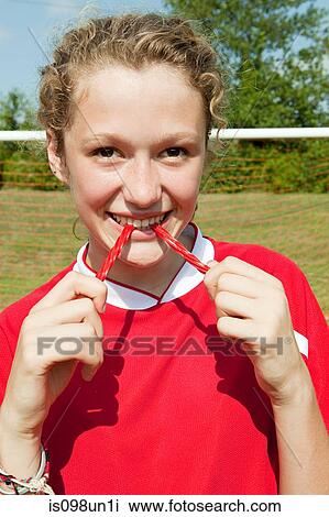 Girl soccer player eating sweet View Large Photo Image Stock Image - Girl soccer player eating sweet. Fotosearch
