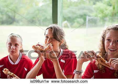 Girl soccer players eating pizza View Large Photo Image Stock Photo - Girl soccer players eating pizza. Fotosearch