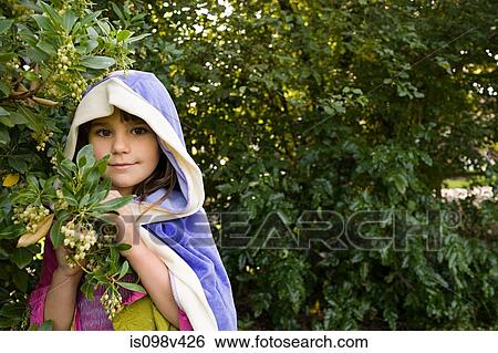 Girl wearing cape with hood hiding in bushes View Large Photo Image Stock Photograph - Girl wearing cape with hood hiding in bushes. Fotosearch