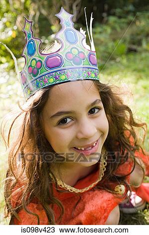 Stock Image - Girl wearing crown dressed up as queen. Fotosearch