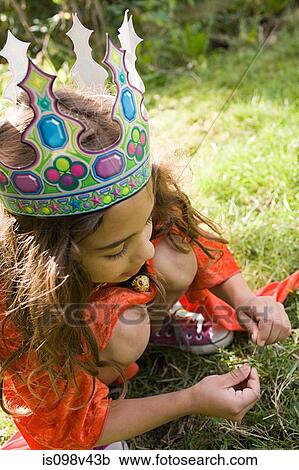 Stock Image - Girl wearing crown dressed up as queen. Fotosearch
