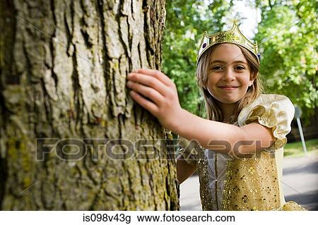 Stock Image - Girl wearing crown dressed up as queen. Fotosearch