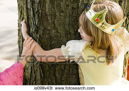 Stock Photograph - Girl wearing crown dressed up as queen. Fotosearch