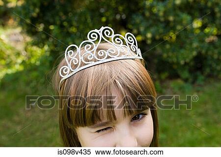Stock Photography - Girl wearing tiara and winking. Fotosearch