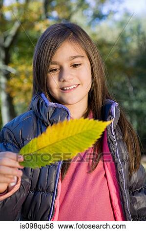 Stock Photo - Girl with a leaf. Fotosearch