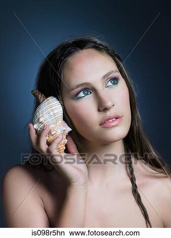Girl with seashell View Large Photo Image Picture - Girl with seashell. Fotosearch