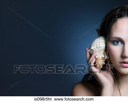 Girl with seashell View Large Photo Image Stock Photograph - Girl with seashell. Fotosearch