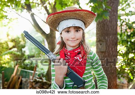 Stock Image - Girls dressed up as cowgirl. Fotosearch