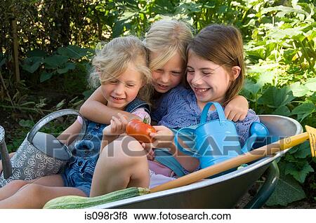 Stock Photo - Girls in a wheelbarrow. Fotosearch