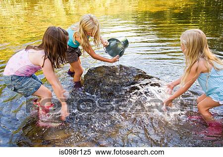 Girls in river with bucket View Large Photo Image Stock Photography - Girls in river with bucket. Fotosearch