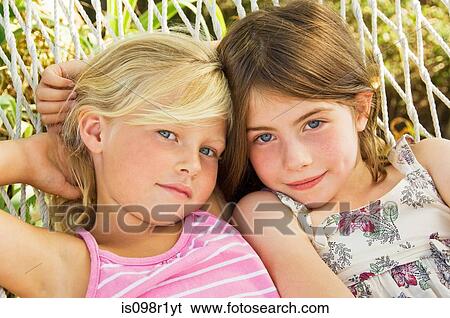 Stock Photograph - Girls of a hammock. Fotosearch