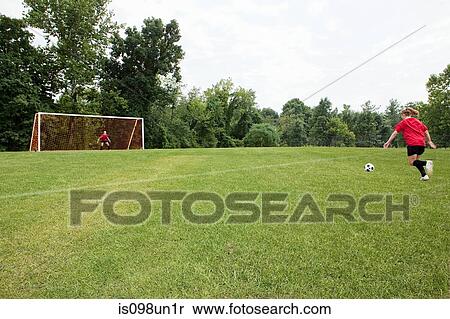 Stock Photography - Girls playing soccer. Fotosearch
