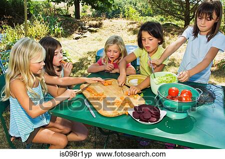 Stock Photography - Girls preparing vegetables. Fotosearch