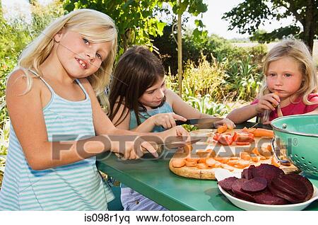 Girls preparing vegetables View Large Photo Image Stock Photography - Girls preparing vegetables. Fotosearch