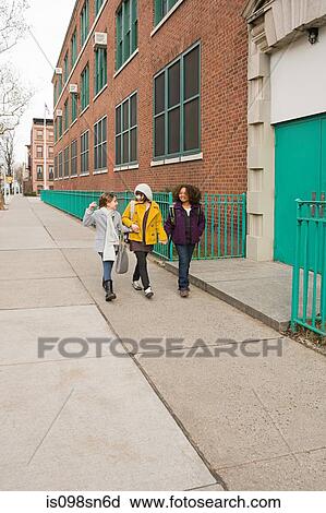 Stock Image - Girls walking to school. Fotosearch