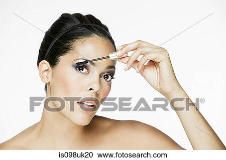 Glamorous woman applying mascara View Large Photo Image Stock Image - Glamorous woman applying mascara. Fotosearch